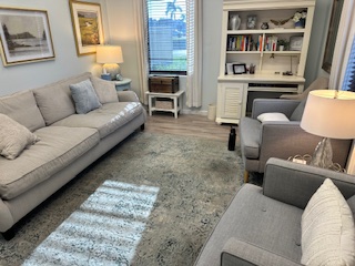 Comfortable therapy room with bookshelf at Florida Coast Counseling Naples office