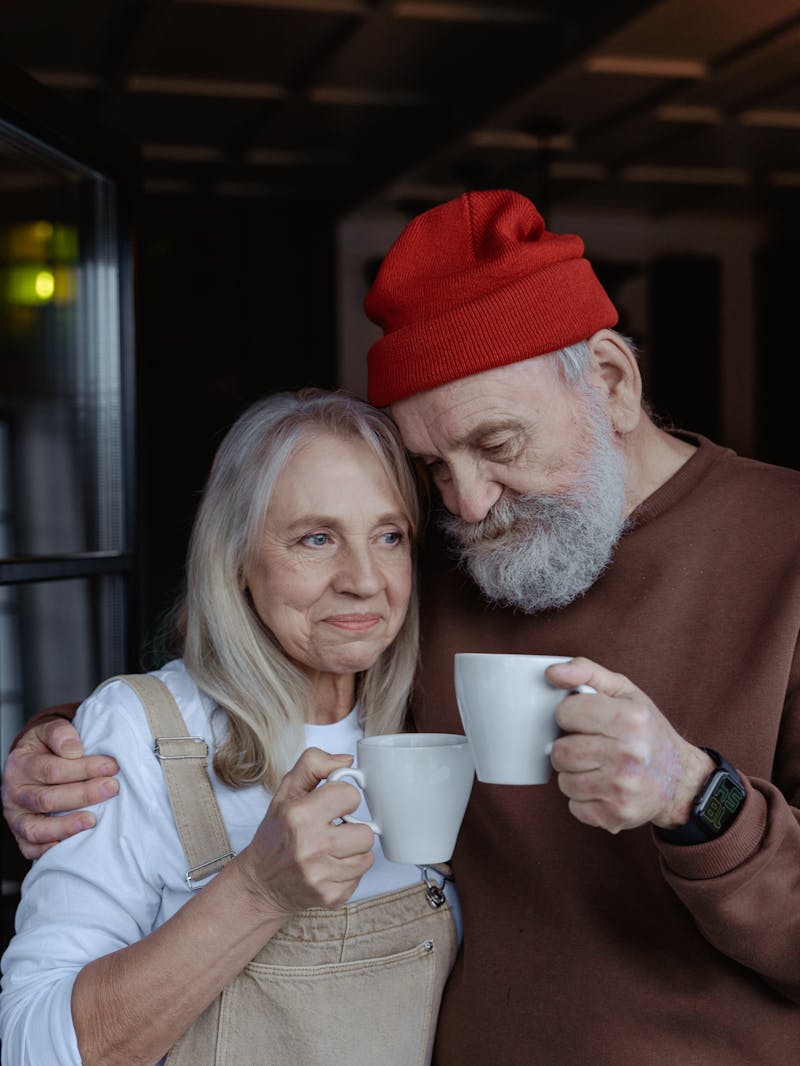 An older married couple sharing morning coffee together, representing the long-arc, everyday work of marriage counseling